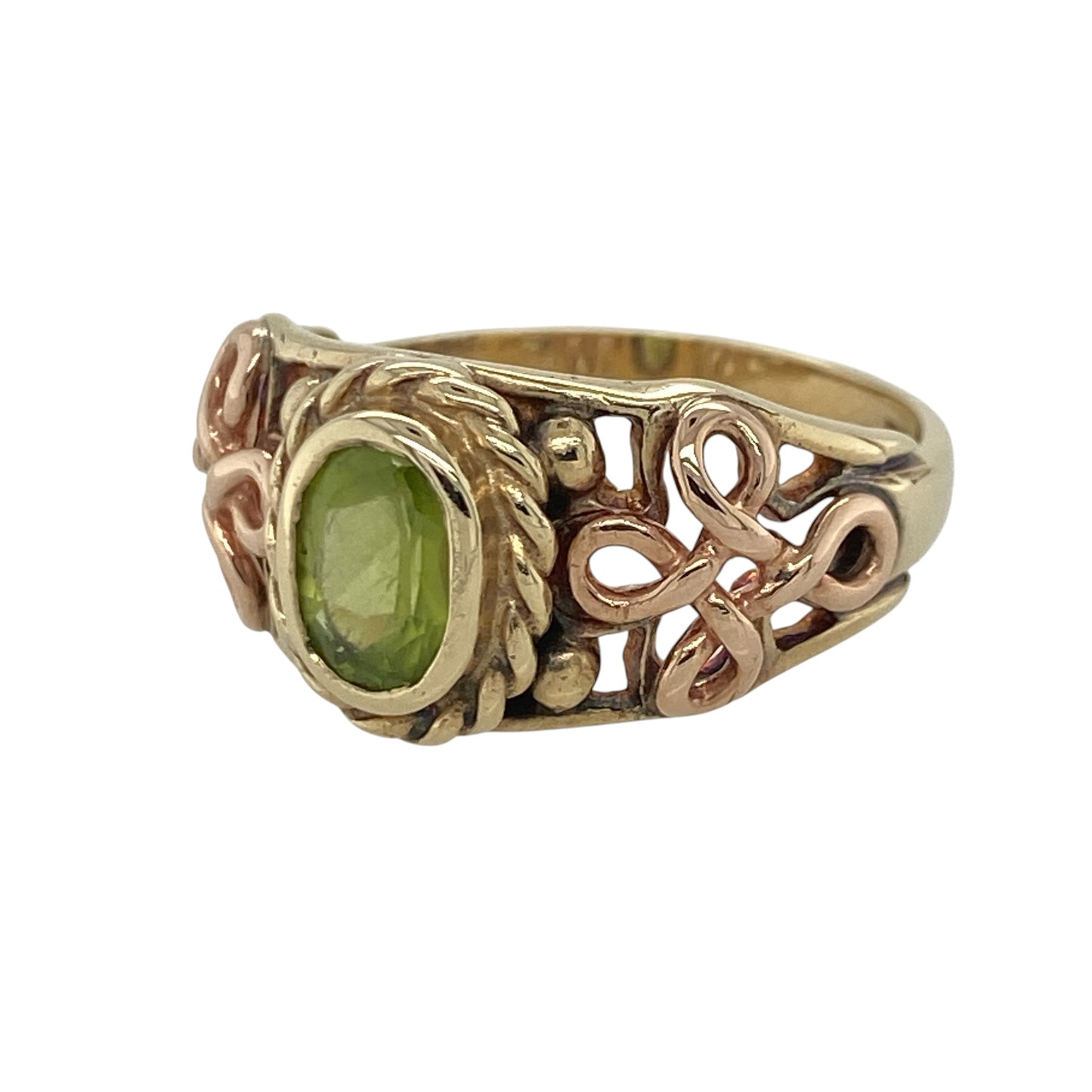 This pre-owned 9ct yellow and rose Welsh gold peridot ring beautifully combines vibrant colour with traditional Celtic-inspired design.

Design: Featuring a striking oval peridot at the centre, this ring is enhanced by intricate Celtic knot detailing on the shoulders in contrasting rose Welsh gold. The band is hallmarked CYM, confirming it contains rare Welsh gold, making it a meaningful and collectible piece.
Material: Made from 9-carat yellow gold with rose Welsh gold detailing.