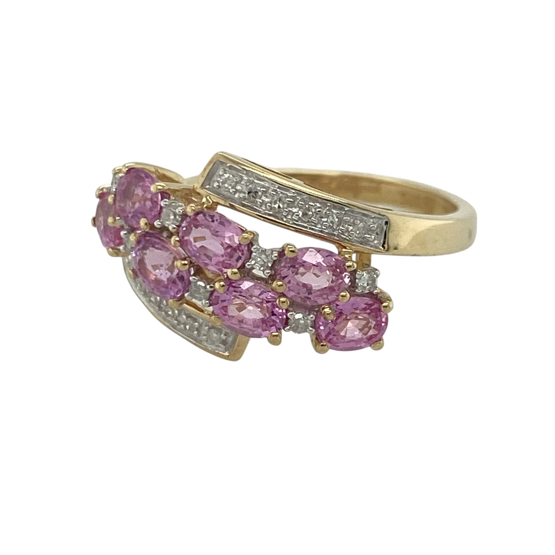 This pre-owned 9ct yellow gold diamond and pink topaz cluster ring is a striking statement piece, showcasing vibrant pink gemstones in an elegant wrap-around design.

Design: Featuring multiple oval pink topaz stones arranged in an eye-catching cluster, this ring is enhanced by sparkling diamonds set between, above and below the gemstones. The wrap-around style band creates a distinctive and elegant look, with the front of the ring measuring approximately 12mm high.
Material: Made from 9-carat yellow gold.