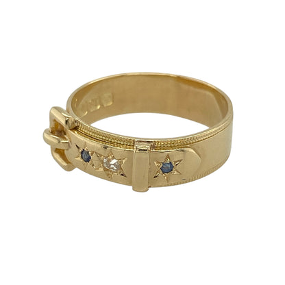 This pre-owned 18ct yellow gold diamond and sapphire buckle ring is a distinctive piece, combining classic gemstones with a timeless buckle design.

Design: Featuring an elegant buckle motif, this ring is set with sparkling diamonds and rich blue sapphires across the front, symbolising strength, loyalty and enduring love. The substantial band measures approximately 6mm wide, while the buckle detail measures approximately 7mm wide, creating a bold yet refined appearance.