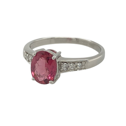 This pre-owned 9ct white gold diamond and pink stone ring is a beautiful combination of soft colour and elegant sparkle.

Design: Featuring a striking oval pink stone at the centre, this elegant ring is enhanced by sparkling diamonds set along the shoulders, adding extra brilliance to the classic design. The polished white gold setting perfectly complements the vibrant pink gemstone, making it an eye-catching choice for everyday wear or special occasions.
Material: Made from 9-carat white gold.