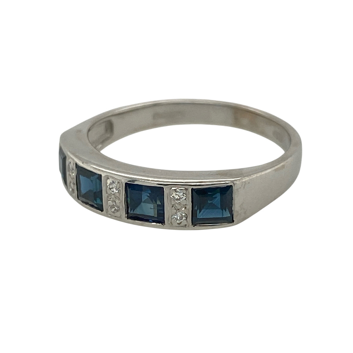 This pre-owned 18ct white gold diamond and sapphire band ring is a timeless piece, combining rich blue sapphires with elegant diamond sparkle.

Design: Featuring four square cut sapphires arranged across the front of the band, with sparkling diamonds set in between, this elegant ring creates a beautiful contrast of deep blue colour and brilliant sparkle. The front of the band measures approximately 4mm wide, making it ideal for everyday wear or as a meaningful anniversary or dress ring.