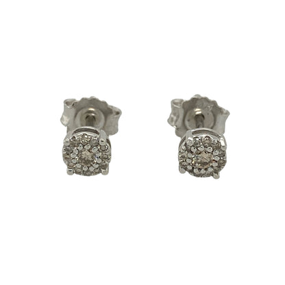 This pre-owned 9ct white gold diamond cluster stud earrings offer timeless elegance with a classic sparkling design.

Design: Featuring a beautiful cluster of sparkling diamonds, these elegant stud earrings create the appearance of a larger centrepiece while maintaining a refined and versatile style. Their polished white gold setting enhances the brilliance of the diamonds, making them perfect for everyday wear or special occasions.
Material: Made from 9-carat white gold.