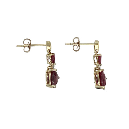 This pair of pre-owned 9ct yellow gold diamond and ruby heart drop earrings beautifully combines romantic design with timeless elegance.

Design: Featuring heart-shaped ruby drops suspended beneath sparkling diamond accents, these elegant earrings offer graceful movement and a beautiful contrast of rich red colour and brilliant sparkle. Their classic drop design makes them perfect for both everyday wear and special occasions.
Material: Made from 9-carat yellow gold.