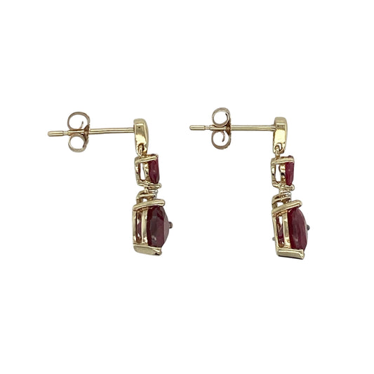 This pair of pre-owned 9ct yellow gold diamond and ruby heart drop earrings beautifully combines romantic design with timeless elegance.

Design: Featuring heart-shaped ruby drops suspended beneath sparkling diamond accents, these elegant earrings offer graceful movement and a beautiful contrast of rich red colour and brilliant sparkle. Their classic drop design makes them perfect for both everyday wear and special occasions.
Material: Made from 9-carat yellow gold.