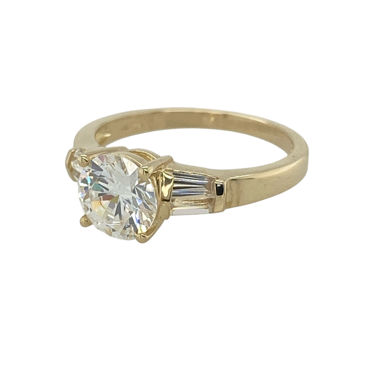 This pre-owned 14ct yellow gold cubic zirconia solitaire ring is a striking and elegant piece, offering timeless style with brilliant sparkle.

Design: Featuring a large round cubic zirconia at the centre, this elegant solitaire ring is enhanced by baguette cut cubic zirconia stones set into the shoulders, adding extra brilliance and a sophisticated finish. The classic yellow gold setting complements the sparkling stones, making it perfect for both everyday wear and special occasions.