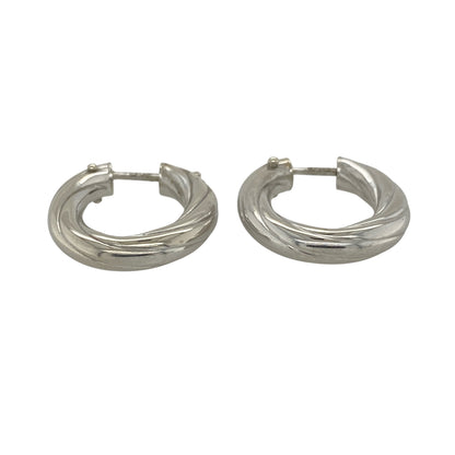 This pair of pre-owned 9ct white gold twisted oval creole earrings offers a timeless design with an elegant contemporary twist.

Design: Featuring a stylish twisted oval hoop design, these polished creole earrings catch the light beautifully, adding subtle texture and shine. Their versatile style makes them perfect for everyday wear while being elegant enough for special occasions.
Material: Made from 9-carat white gold.
Size & Weight: Total weight 3.00 grams.