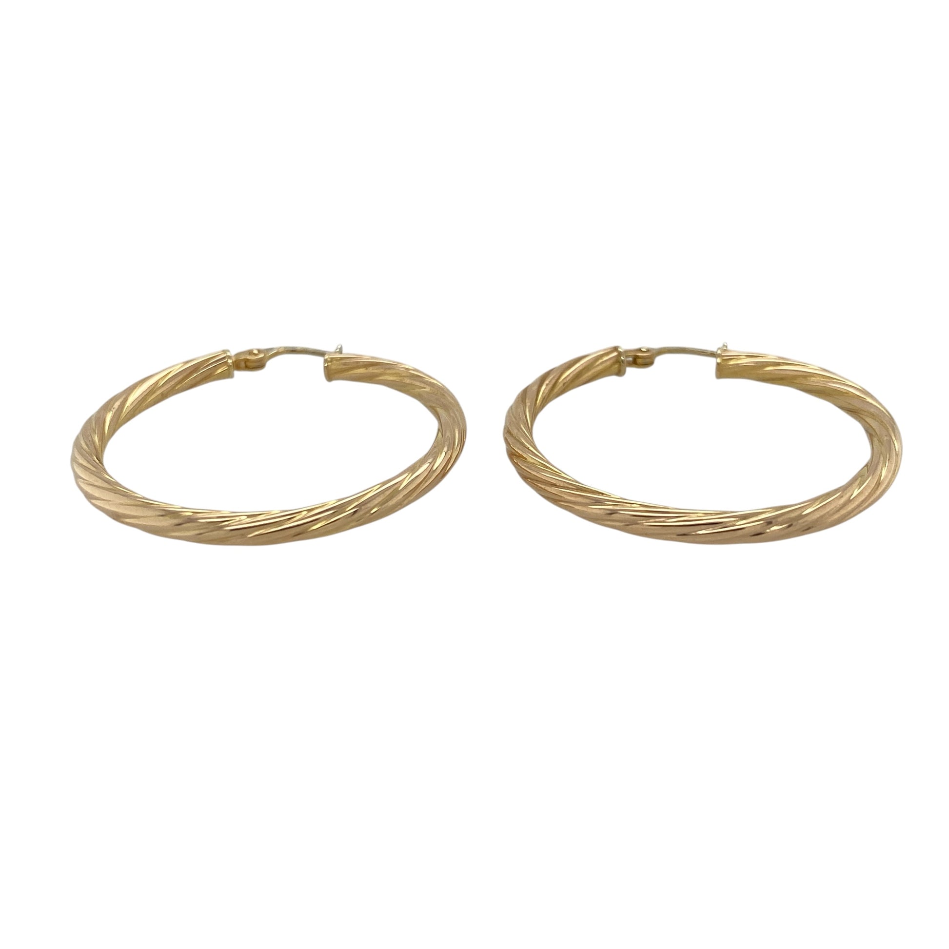 This pair of pre-owned 9ct yellow gold twisted hoop creole earrings combines timeless style with a classic twisted finish.

Design: Featuring an elegant twisted hoop design, these polished creole earrings catch the light beautifully, adding texture and sparkle to a timeless style. Measuring approximately 35mm in diameter, they offer a bold yet lightweight look, making them ideal for everyday wear or special occasions.
Material: Made from 9-carat yellow gold.
Size & Weight: Hoop diameter approximately 35mm.