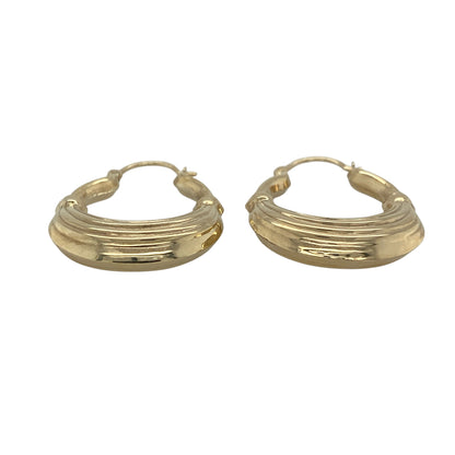 This pair of pre-owned 9ct yellow gold large textured oval creole earrings offers a bold yet timeless look, perfect for everyday elegance.

Design: Featuring a large oval creole shape with a beautifully textured finish, these earrings catch the light from every angle, adding extra depth and sparkle. Their classic yet eye-catching design makes them a versatile accessory that complements both casual and formal outfits.
Material: Made from 9-carat yellow gold.
Size & Weight: Total weight 3.50 grams.
