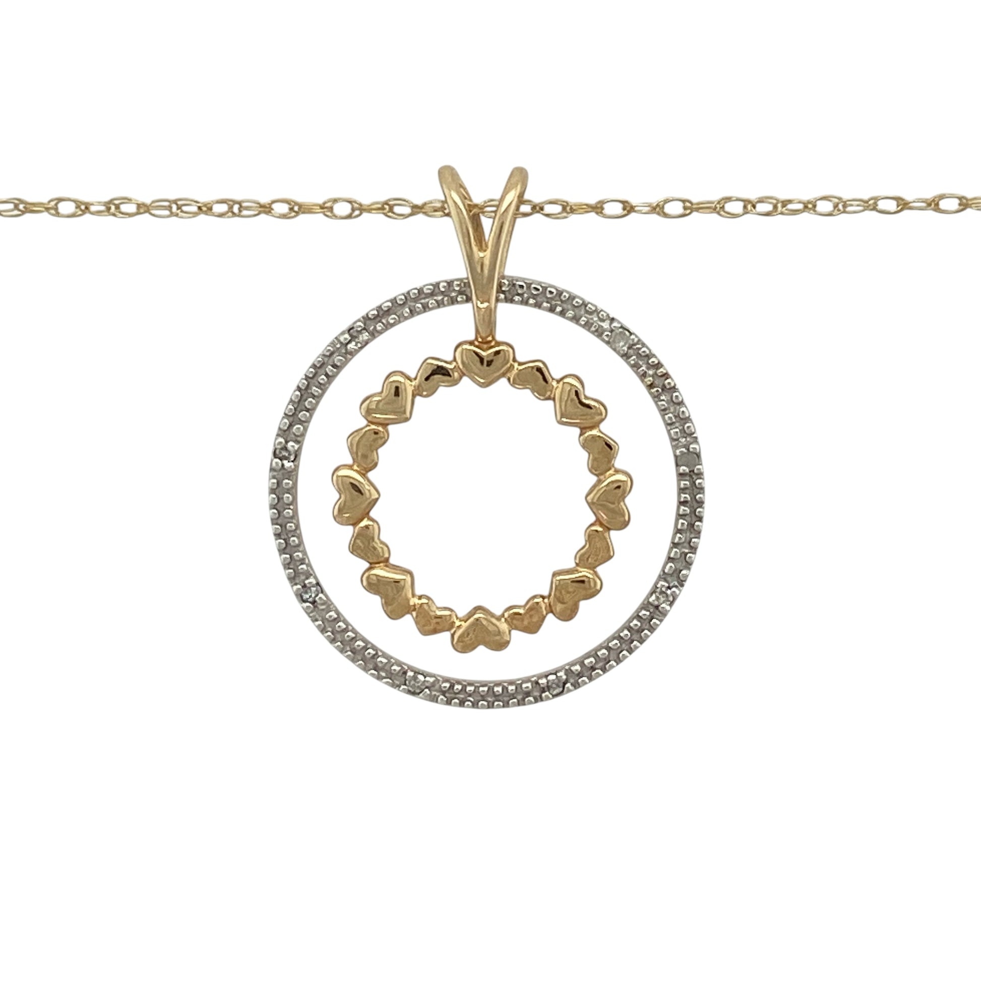This pre-owned 9ct yellow and white gold diamond double heart circle pendant necklace is a beautifully symbolic design, combining two-tone gold with sparkling diamonds.

Design: Featuring two interlocking circles, this elegant pendant showcases a white gold circle set with shimmering diamonds alongside a yellow gold circle formed from a series of polished hearts. Suspended from an 18-inch Prince of Wales chain, the pendant measures approximately 2.8cm long including the bail