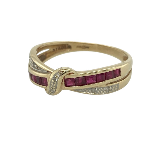 This pre-owned 9ct yellow gold diamond and ruby crossover band ring is a striking design, combining rich red rubies with sparkling diamonds in an elegant crossover setting.

Design: Featuring a stylish crossover band measuring approximately 6mm wide across the front, this ring is set with vibrant square-cut rubies and sparkling small diamonds for a beautiful contrast of colour and brilliance.