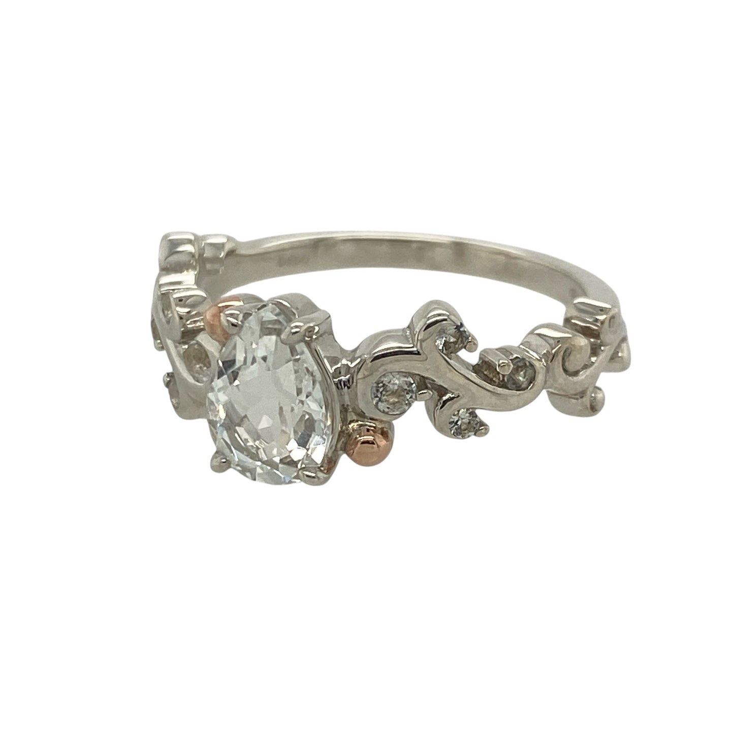 This pre-owned Clogau white topaz solitaire ring is an elegant sterling silver and 9ct rose gold design, featuring a sparkling pear-shaped gemstone with beautifully detailed shoulders.

Design: Featuring a striking pear-shaped white topaz in a classic solitaire setting, this elegant ring is enhanced by sparkling white topaz set along the shoulders and signature 9ct rose gold detailing.