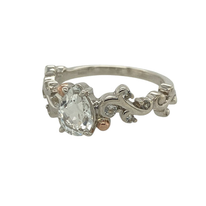 This pre-owned Clogau white topaz solitaire ring is an elegant sterling silver and 9ct rose gold design, featuring a sparkling pear-shaped gemstone with beautifully detailed shoulders.

Design: Featuring a striking pear-shaped white topaz in a classic solitaire setting, this elegant ring is enhanced by sparkling white topaz set along the shoulders and signature 9ct rose gold detailing.