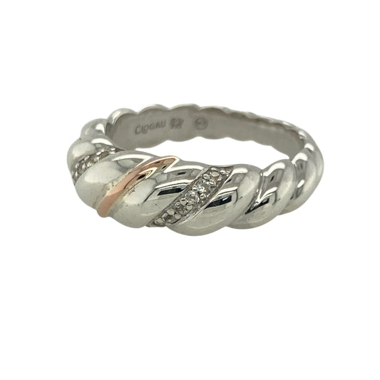 This pre-owned Clogau twist band ring is a beautiful sterling silver and 9ct rose gold design, finished with sparkling white topaz for an elegant two-tone look.

Design: Featuring a flowing twist band design, this Clogau ring combines polished sterling silver with signature 9ct rose gold detailing and sparkling white topaz stones. Measuring approximately 7mm wide across the front, the intertwined design creates a distinctive piece inspired by Welsh heritage.