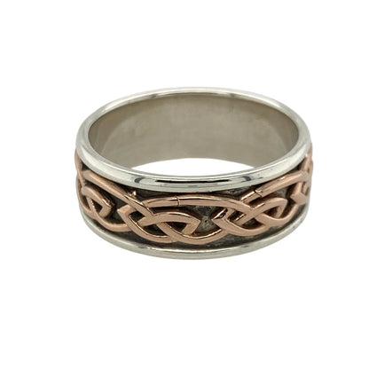 Bring rich symbolism and timeless elegance to your collection with this pre-owned 925 silver with 9ct rose gold Clogau Annwyl Celtic knot band ring, offering a bold design and meaningful presence—perfect for making a refined statement.

Design: The ring features an 8mm wide band adorned with an intricate Celtic knot pattern, symbolising eternal love and interconnectedness. The combination of silver and rose gold creates a striking contrast and a beautifully detailed look.