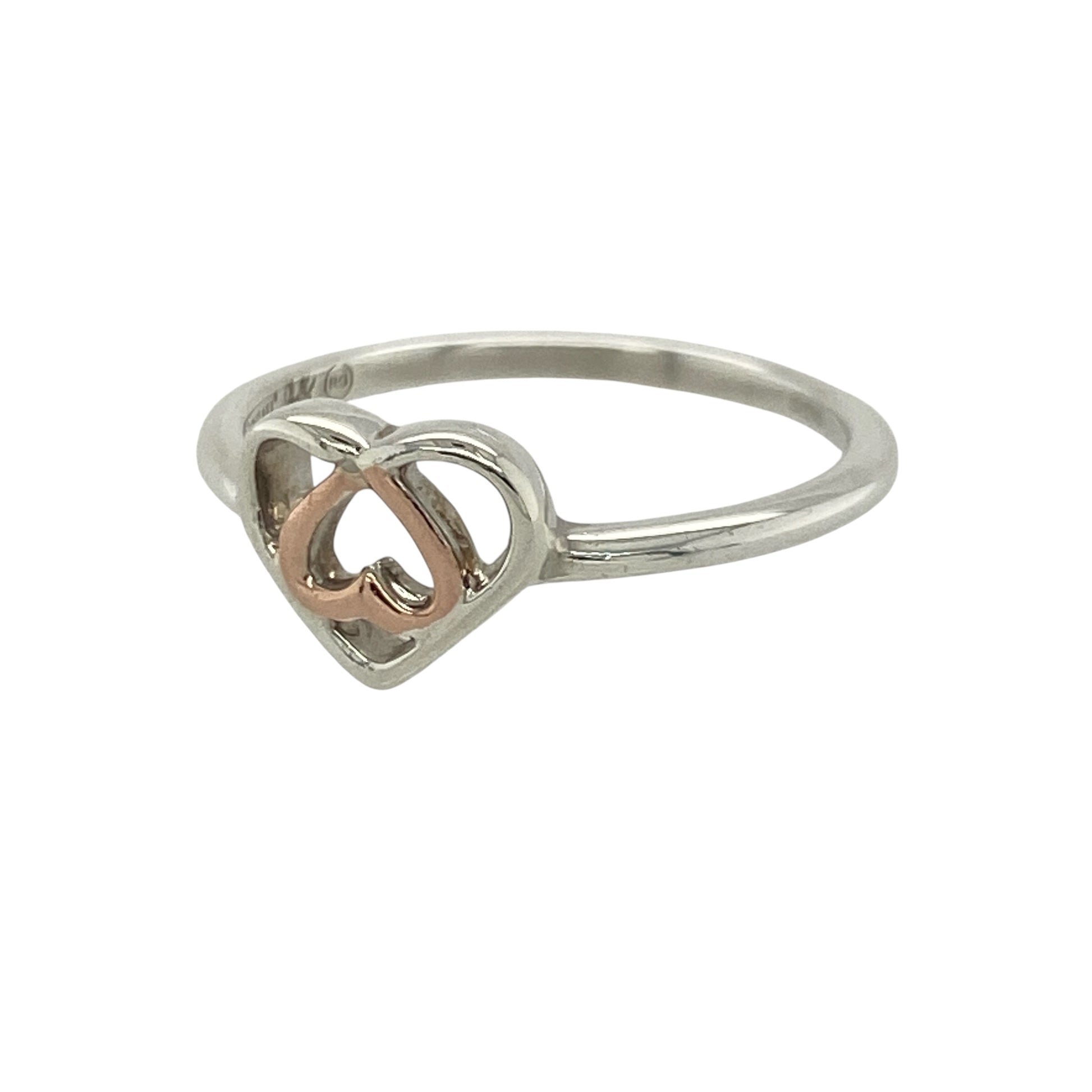 This pre-owned Clogau heart ring is a delicate sterling silver and 9ct rose gold design, combining a romantic heart motif with classic two-tone styling.

Design: Featuring a charming heart design with signature 9ct rose gold detailing, this Clogau ring beautifully combines polished sterling silver with warm rose gold. The front measures approximately 7mm high, giving the ring a delicate and versatile look that is perfect for everyday wear or as a meaningful gift.