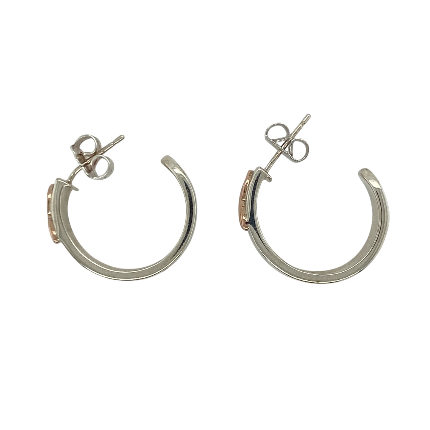 These pre-owned Clogau Cariad hoop stud earrings are a beautiful sterling silver and 9ct rose gold design, combining classic hoop styling with distinctive Welsh-inspired detailing.

Design: Featuring the elegant Clogau Cariad design, these hoop stud earrings combine polished sterling silver with signature 9ct rose gold detailing for a timeless two-tone finish. Their substantial design makes them an eye-catching pair while remaining versatile enough for both everyday wear and special occasions.