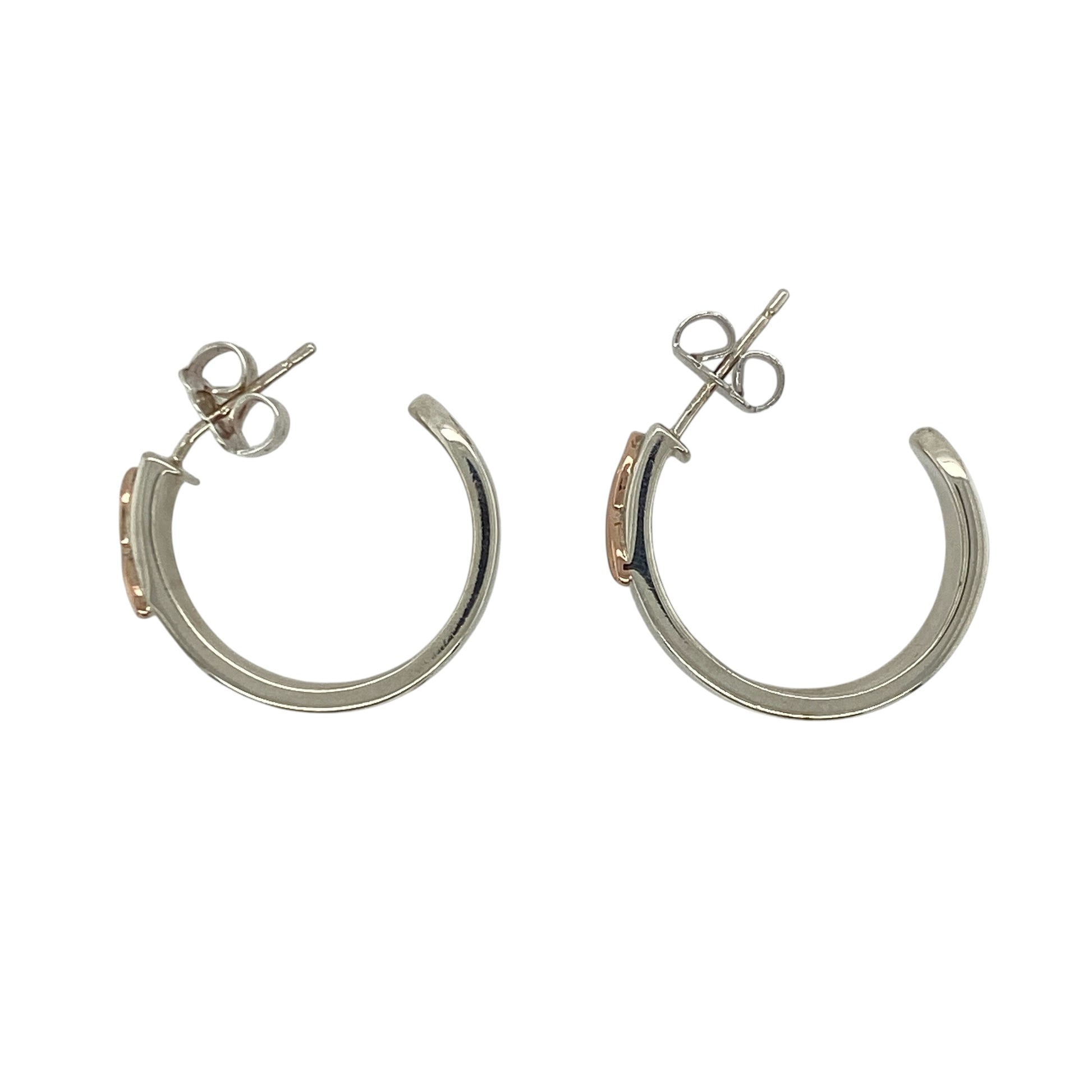 These pre-owned Clogau Cariad hoop stud earrings are a beautiful sterling silver and 9ct rose gold design, combining classic hoop styling with distinctive Welsh-inspired detailing.

Design: Featuring the elegant Clogau Cariad design, these hoop stud earrings combine polished sterling silver with signature 9ct rose gold detailing for a timeless two-tone finish. Their substantial design makes them an eye-catching pair while remaining versatile enough for both everyday wear and special occasions.
