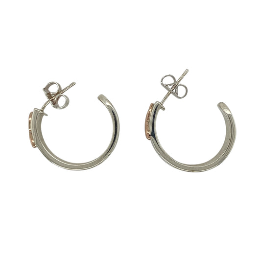 These pre-owned Clogau Cariad hoop stud earrings are a beautiful sterling silver and 9ct rose gold design, combining classic hoop styling with distinctive Welsh-inspired detailing.

Design: Featuring the elegant Clogau Cariad design, these hoop stud earrings combine polished sterling silver with signature 9ct rose gold detailing for a timeless two-tone finish. Their substantial design makes them an eye-catching pair while remaining versatile enough for both everyday wear and special occasions.