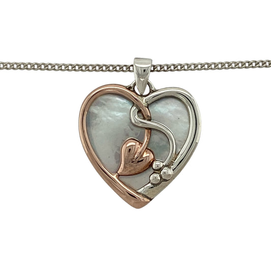 This pre-owned Clogau Mother of Pearl heart pendant necklace is a beautiful sterling silver and 9ct rose gold design, combining soft iridescent tones with a romantic heart motif.

Design: Featuring a heart-shaped pendant with Mother of Pearl and signature 9ct rose gold detailing, this Clogau necklace beautifully combines polished sterling silver with warm rose gold. The pendant measures approximately 2.6cm long including the bail and is suspended from an 18-inch Clogau curb chain.