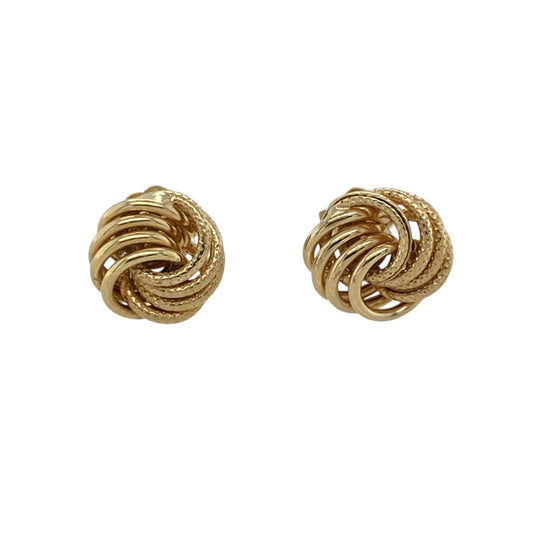 These pre-owned 9ct yellow gold patterned knot stud earrings are a classic and versatile design, featuring decorative detailing across the intertwined knot shape.

Design: Featuring an elegant knot design with patterned detailing, these stud earrings offer a timeless look with added texture and character. Measuring approximately 8mm, their compact size makes them ideal for comfortable everyday wear.
Material: Made from 9-carat yellow gold.
