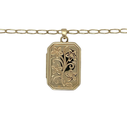 This pre-owned 9ct yellow gold flower patterned rectangle locket necklace is a classic design, combining delicate floral detailing with a timeless locket style.

Design: Featuring a rectangular locket decorated with an elegant flower pattern, this necklace offers a traditional design with decorative detail. The locket measures approximately 2.6cm long including the bail and is suspended from a 20-inch open curb chain.
Material: Made from 9-carat yellow gold.