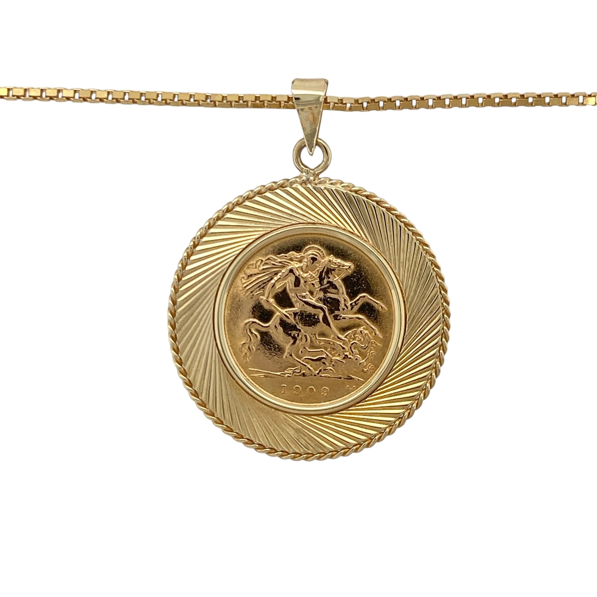 This pre-owned 9ct yellow gold half sovereign pendant necklace is a substantial design, featuring a 1909 22ct gold King Edward VII half sovereign coin within a decorative textured mount.

Design: Featuring a 1909 King Edward VII half sovereign coin set within a 9ct yellow gold mount with a textured surround, this pendant combines classic coin jewellery with decorative gold detailing. The pendant measures approximately 4.1cm long including the bail and is suspended from a 19-inch box chain.