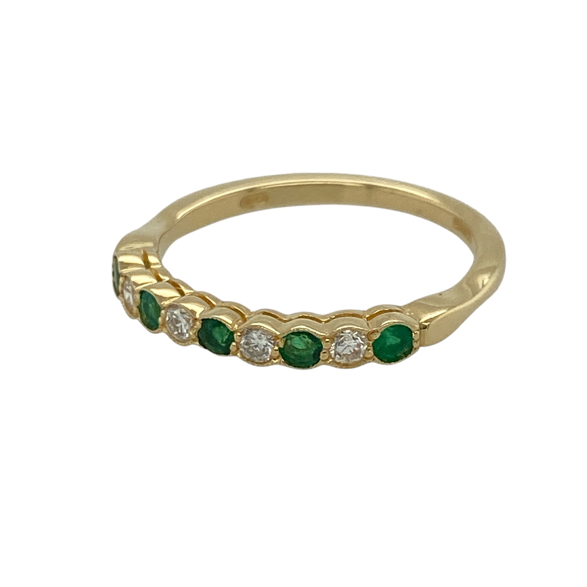 This pre-owned 18ct yellow gold diamond and emerald band ring is a classic gemstone design, featuring alternating emeralds and diamonds across the front.

Design: Featuring round emeralds alternating with diamonds across the band, this ring combines rich green tones with classic diamond detailing and warm 18ct yellow gold.
Material: Made from 18-carat yellow gold.
Gemstone Detail: Round emeralds measuring approximately 2mm in diameter, alternating with diamonds.