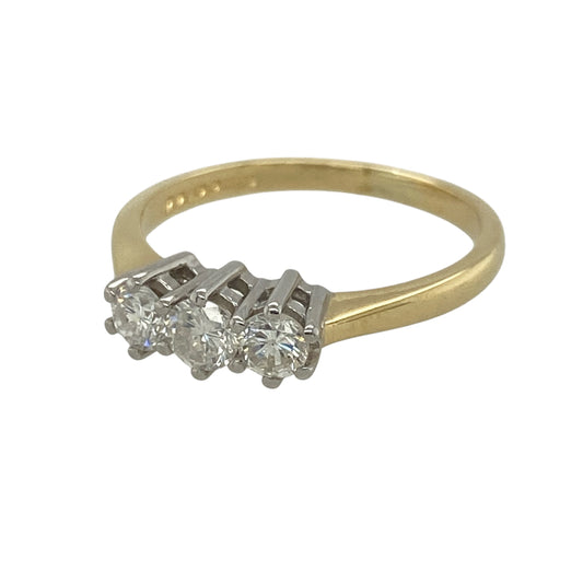 This pre-owned 18ct yellow gold diamond trilogy ring is a timeless three stone design, featuring approximately 0.45ct of diamond content in total.

Design: Featuring three diamonds set across the front, this classic trilogy ring combines a traditional three stone design with warm 18ct yellow gold.
Material: Made from 18-carat yellow gold.
Gemstone Detail: Three diamonds with approximately 0.45ct of diamond content set in total and approximate SI clarity.
Ring Detail: Classic three stone trilogy setting.