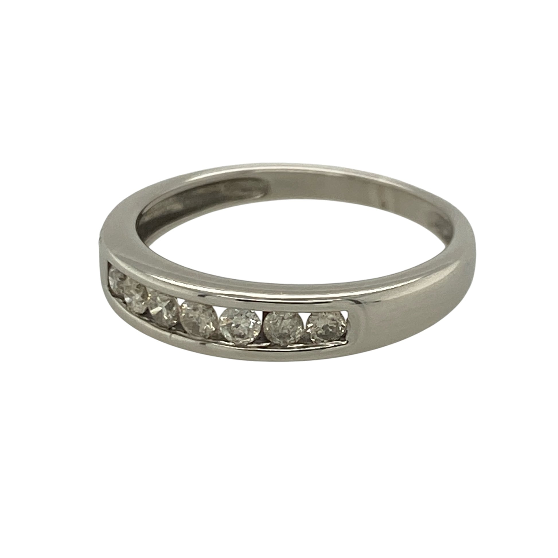 This pre-owned 9ct white gold diamond band ring is a classic seven stone design, featuring approximately 0.25ct of brilliant cut diamond content in total.

Design: Featuring seven brilliant cut diamonds set across the front of the band, this ring combines a timeless diamond design with the bright finish of 9ct white gold.
Material: Made from 9-carat white gold.
Gemstone Detail: Seven brilliant cut diamonds with approximately 0.25ct of diamond content set in total.