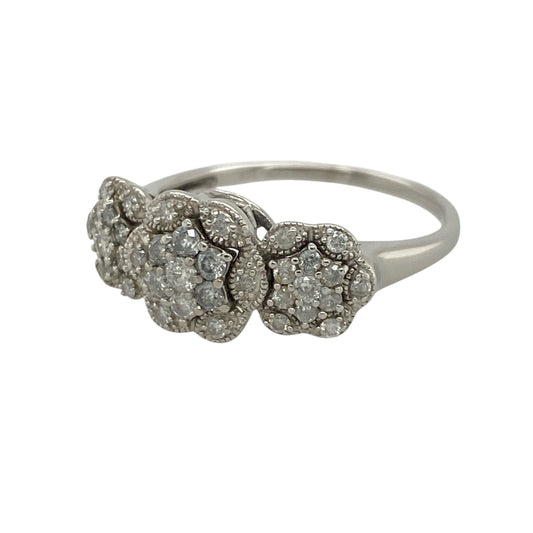 This pre-owned 9ct white gold diamond trilogy flower cluster ring is an eye-catching design, featuring three floral-style diamond clusters with approximately 0.50ct of diamond content in total.

Design: Featuring three flower-shaped diamond clusters arranged in a trilogy design, this ring combines floral detailing with the bright finish of 9ct white gold. The front of the ring measures approximately 9mm high, creating a distinctive statement look.
Material: Made from 9-carat white gold.