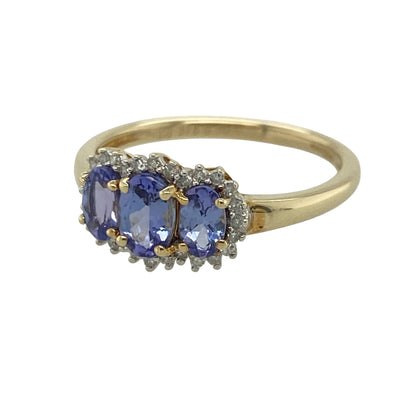 This pre-owned 9ct yellow gold diamond and tanzanite trilogy cluster ring is a colourful three stone design, featuring three oval tanzanites individually surrounded by diamonds.

Design: Featuring three oval tanzanites arranged in a trilogy design, each stone is surrounded by diamonds to create three individual clusters across the front of the ring. The rich tones of the tanzanite contrast beautifully against the warm yellow gold.
Material: Made from 9-carat yellow gold.
