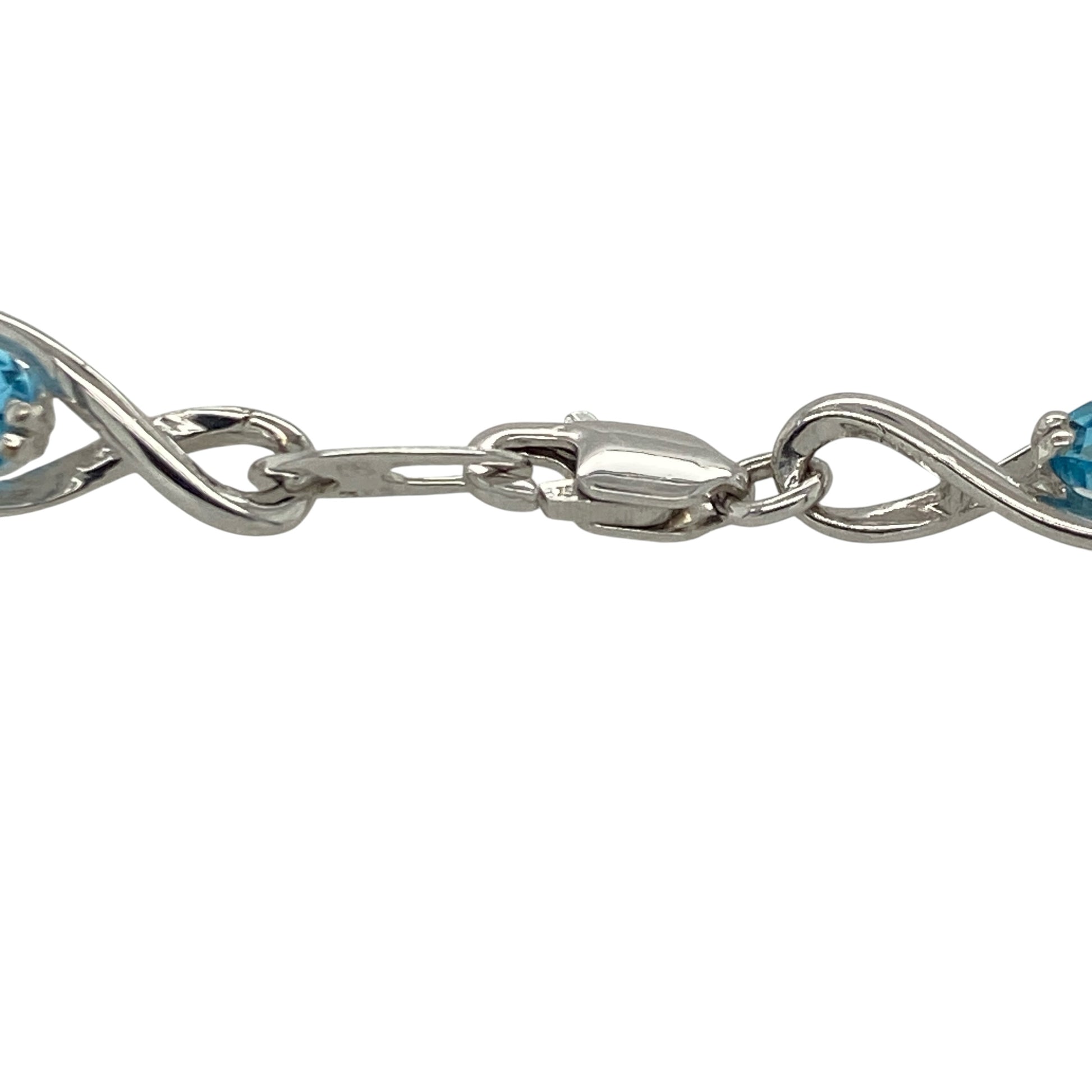 This pre-owned 9ct white gold diamond and blue topaz bracelet is an elegant gemstone design, featuring oval blue topaz stones with diamond detailing.

Design: Featuring oval blue topaz stones accented with diamonds throughout the bracelet, this piece combines cool blue tones with the bright finish of 9ct white gold.
Material: Made from 9-carat white gold.
Gemstone Detail: Oval blue topaz stones measuring approximately 6mm by 4mm each, accented with diamonds.