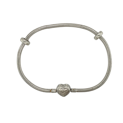 This pre-owned Clogau charm bracelet is a classic two-tone design, combining 925 silver with signature 9ct rose gold detailing and a meaningful heart-shaped clasp.

Design: Featuring a traditional charm bracelet design, this Clogau bracelet has a heart-shaped clasp detailed with the words "Love, Luck and Happiness", adding a meaningful finishing touch to the piece.
Material: Made from 925 silver with 9-carat rose gold detailing.
