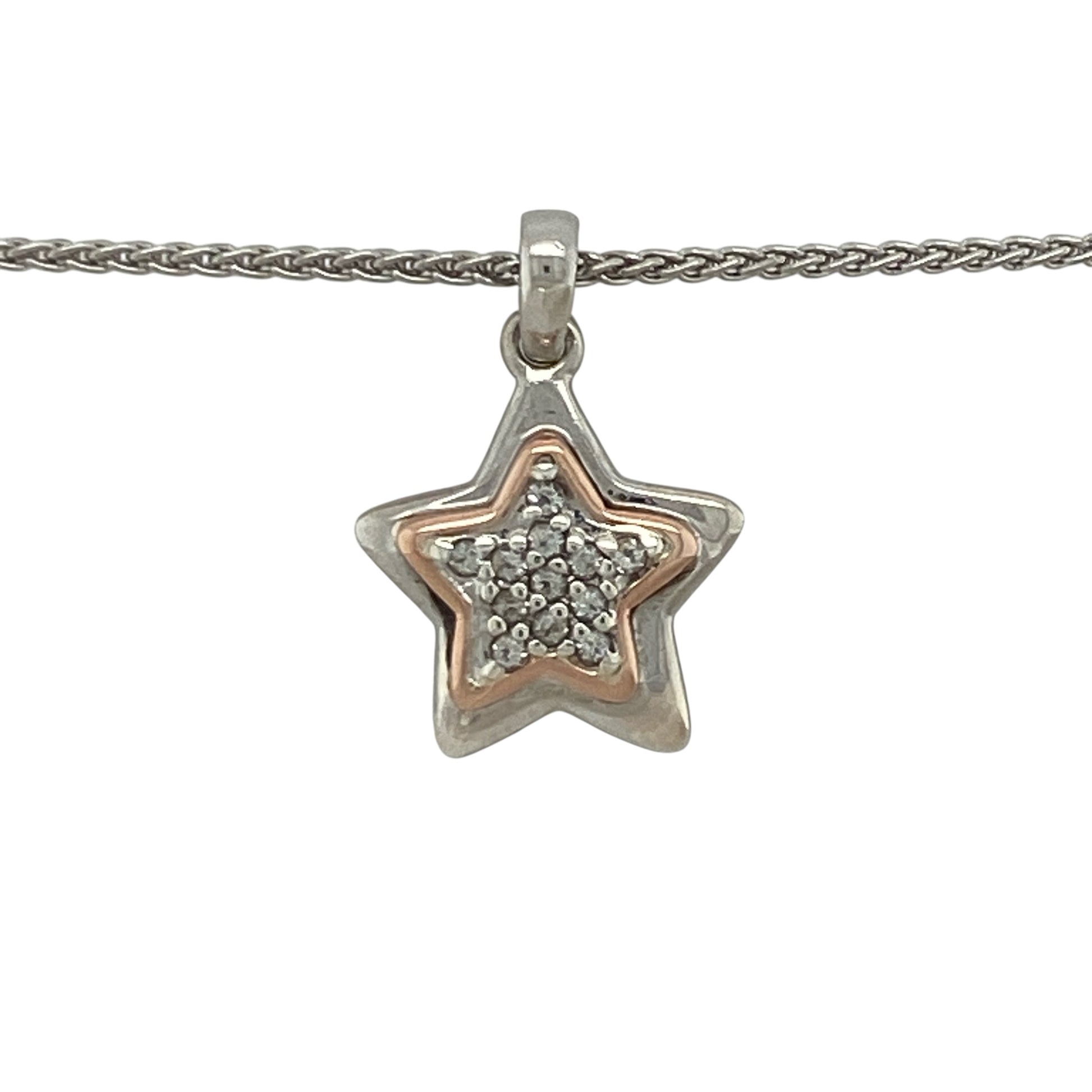 This pre-owned Clogau star pendant necklace is a delicate two-tone design, combining 925 silver with 9ct rose gold and white topaz detailing.

Design: Featuring a star-shaped pendant with contrasting rose gold and white topaz detailing, this Clogau piece is suspended from a 16-inch wheat chain for a classic finish.
Material: Made from 925 silver with 9-carat rose gold detailing.
Gemstone Detail: Set with white topaz.
Pendant Detail: Star pendant measuring approximately 2.1cm long including the bail.