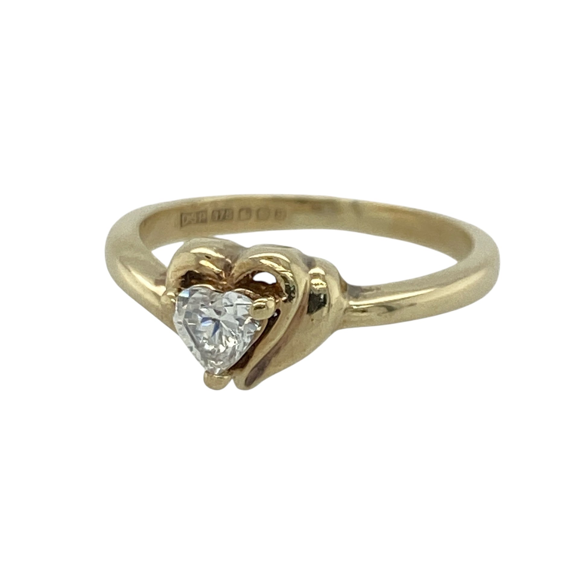 This pre-owned 9ct yellow gold cubic zirconia heart ring is a delicate design, featuring a heart-shaped cubic zirconia as the centrepiece.

Design: Featuring a heart-shaped cubic zirconia set at the centre, this ring combines a romantic heart design with the warm finish of 9ct yellow gold.
Material: Made from 9-carat yellow gold.
Gemstone Detail: Heart-shaped cubic zirconia measuring approximately 4mm.
Ring Detail: Heart-shaped gemstone ring design.
Size & Weight: Ring size J. Total weight 2.20 grams.