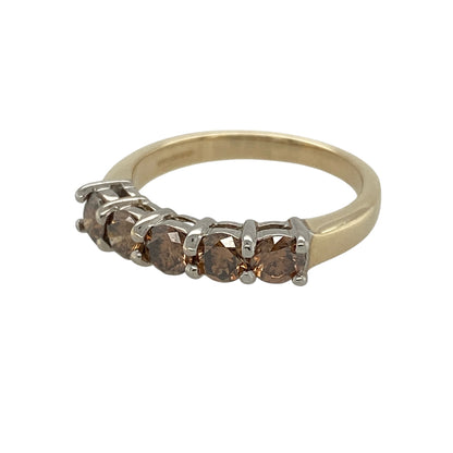 This pre-owned 9ct yellow gold chocolate coloured diamond band ring is a distinctive design, featuring approximately 0.70ct of diamond content.

Design: Featuring chocolate coloured diamonds set across the band, this ring combines the rich tone of the diamonds with the warm finish of 9ct yellow gold.
Material: Made from 9-carat yellow gold.
Gemstone Detail: Approximately 0.70ct of chocolate coloured diamond content in total with approximate I1 clarity.
Ring Detail: Diamond set band design.
