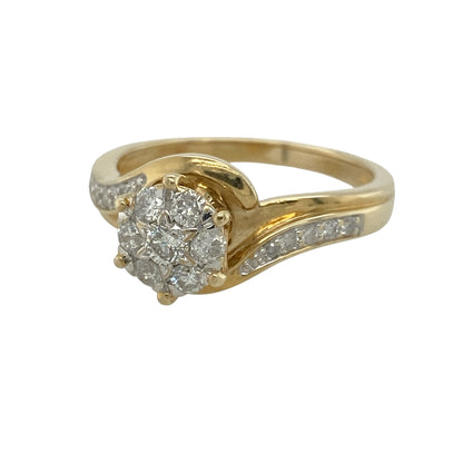 This pre-owned 9ct yellow gold diamond illusion set solitaire cluster ring is a striking design, using multiple diamonds to create the appearance of a larger solitaire centre.

Design: Featuring an illusion set solitaire-style cluster, this ring brings multiple diamonds together to create a larger central appearance, finished in warm 9ct yellow gold.
Material: Made from 9-carat yellow gold.
Gemstone Detail: Approximately 0.50ct of diamond content set in total.