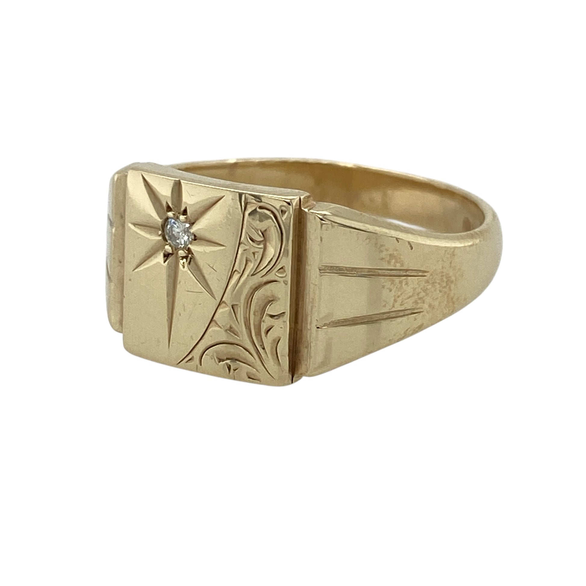 This pre-owned 9ct yellow gold diamond signet ring is a distinctive design, featuring a starburst setting with a diamond at the centre.

Design: Featuring a patterned signet design with a starburst set diamond, this ring combines decorative detailing with the warm finish of 9ct yellow gold.
Material: Made from 9-carat yellow gold.
Gemstone Detail: Set with a diamond within the starburst design.
Ring Detail: Front of the ring measures approximately 10mm high.