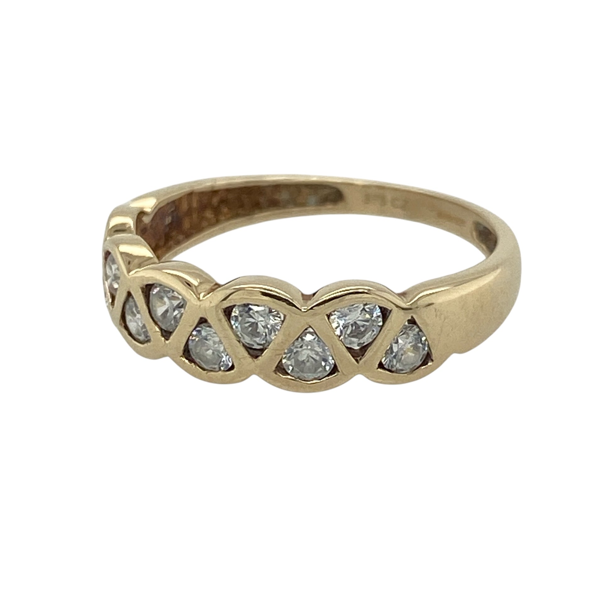 This pre-owned 9ct yellow gold cubic zirconia weave band ring is a decorative design, featuring round cubic zirconia stones set within a woven-style band.

Design: Featuring a weave-style design set with round cubic zirconia stones, this ring combines decorative detailing with the warm finish of 9ct yellow gold.
Material: Made from 9-carat yellow gold.
Gemstone Detail: Round cubic zirconia stones each measuring approximately 2mm in diameter.
Ring Detail: Front of the band measures approximately 5mm wide.