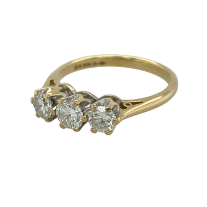This pre-owned 18ct yellow gold diamond trilogy ring is a timeless three-stone design, featuring approximately 0.75ct of diamond content in total.

Design: Featuring a classic trilogy setting with three diamonds set alongside one another, this ring combines a traditional design with the warm finish of 18ct yellow gold.
Material: Made from 18-carat yellow gold.
Gemstone Detail: Approximately 0.75ct of diamond content set in total across the three stones.
Ring Detail: Classic three-stone trilogy design.