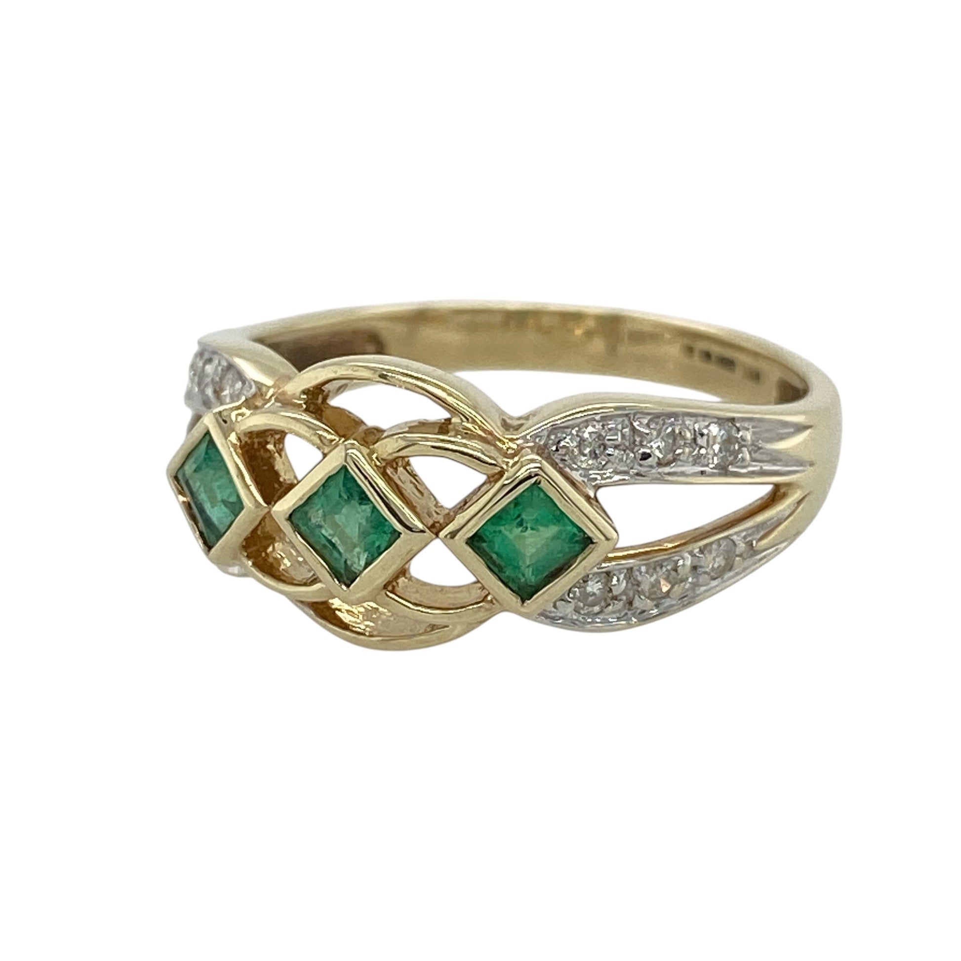 This pre-owned 9ct yellow gold diamond and emerald band ring is a classic gemstone design, featuring three square emeralds with diamond set shoulders.

Design: Featuring three square emeralds set across the front with diamonds along the shoulders, this ring combines rich green tones with the warm finish of 9ct yellow gold.
Material: Made from 9-carat yellow gold.
Gemstone Detail: Three square emeralds each measuring approximately 3mm by 3mm, with diamonds set on the shoulders.