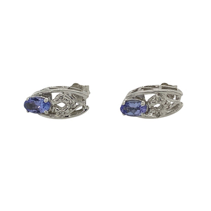 These pre-owned 9ct white gold diamond and tanzanite stud earrings are a classic gemstone design, featuring oval tanzanite stones with diamond detailing.

Design: Featuring oval tanzanite stones with diamond detailing, these stud earrings combine the blue-purple tones of tanzanite with the bright finish of 9ct white gold.
Material: Made from 9-carat white gold.
Gemstone Detail: Oval tanzanite stones each measuring approximately 5mm by 3mm with diamond detailing.