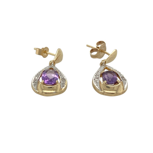 These pre-owned 9ct yellow gold diamond and amethyst drop earrings are a classic gemstone design, featuring oval amethyst stones with diamond detailing.

Design: Featuring oval amethyst stones with diamond detailing, these drop earrings combine rich purple tones with the warm finish of 9ct yellow gold.
Material: Made from 9-carat yellow gold.
Gemstone Detail: Oval amethyst stones each measuring approximately 6mm by 4mm with diamond detailing.
Earring Detail: Diamond and amethyst drop earring design.