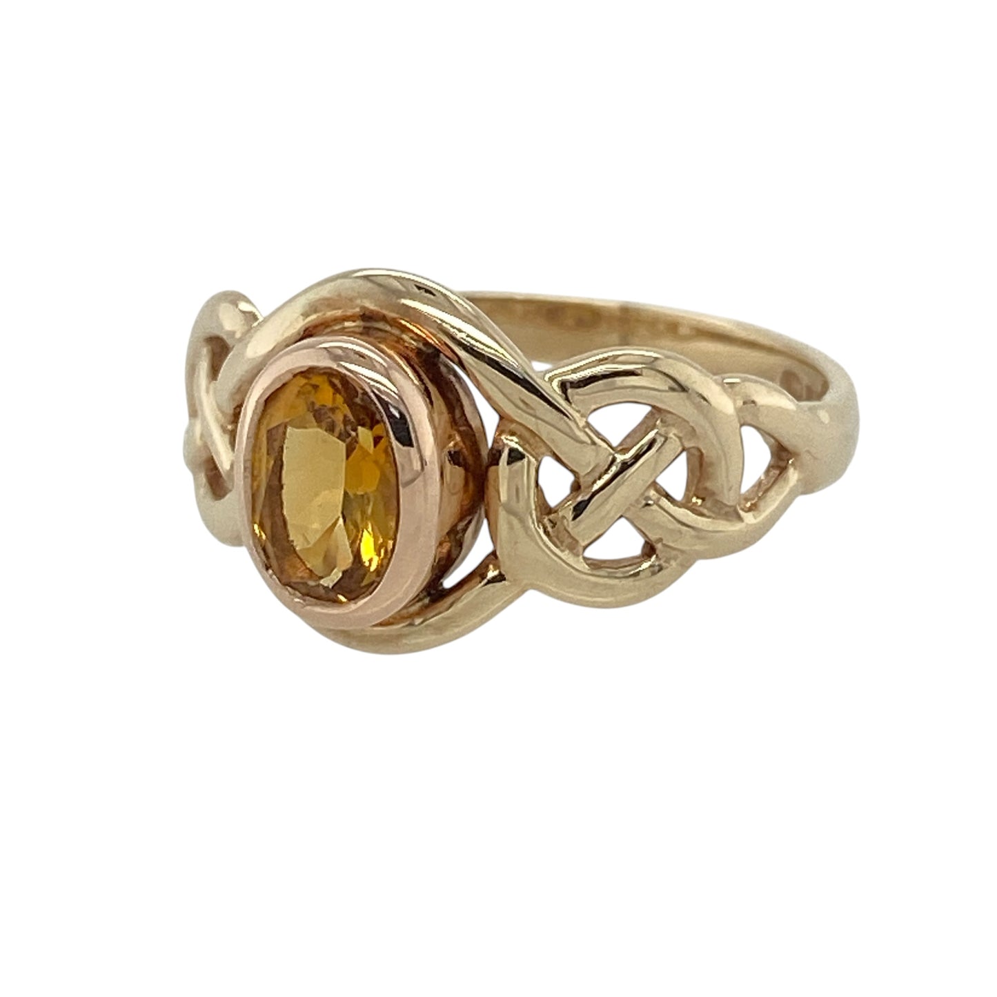 This pre-owned 9ct yellow and rose gold Clogau citrine birthstone ring is a distinctive Celtic-inspired design, featuring an oval citrine stone with contrasting gold detailing.

Design: Featuring a Celtic-inspired design in yellow and rose gold, this Clogau birthstone ring is centred with an oval citrine stone.
Material: Made from 9-carat yellow and rose gold.
Gemstone Detail: Oval citrine stone measuring approximately 6mm by 4mm.
Ring Detail: Clogau birthstone ring with Celtic-style detailing.