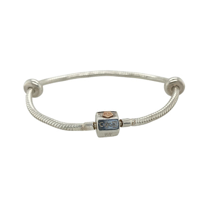 This pre-owned Clogau charm bracelet is a beautiful sterling silver and 9ct rose gold design, complete with two stoppers ready for adding your favourite charms.

Design: Featuring a classic Clogau charm bracelet design, this piece combines polished sterling silver with signature 9ct rose gold detailing for a timeless two-tone finish. Complete with two stoppers to help keep charms securely positioned, the bracelet can be personalised with a selection of meaningful charms to create a unique piece of jewellery