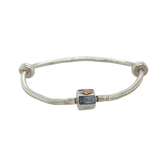 This pre-owned Clogau charm bracelet is a beautiful sterling silver and 9ct rose gold design, complete with two stoppers ready for adding your favourite charms.

Design: Featuring a classic Clogau charm bracelet design, this piece combines polished sterling silver with signature 9ct rose gold detailing for a timeless two-tone finish. Complete with two stoppers to help keep charms securely positioned, the bracelet can be personalised with a selection of meaningful charms to create a unique piece of jewellery