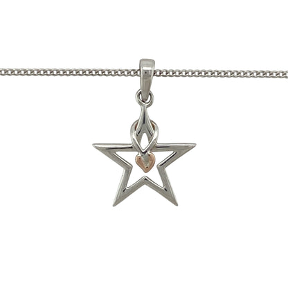 This pre-owned Clogau ‘Starlight’ pendant necklace is a distinctive two-tone design, featuring a star shape with signature Tree of Life detailing.

Design: Featuring a star-shaped ‘Starlight’ pendant with Clogau’s iconic Tree of Life detailing, this necklace combines polished silver with contrasting 9ct rose gold accents.
Material: Made from 925 sterling silver with 9-carat rose gold detailing.
Pendant Detail: Star-shaped pendant measures approximately 2.1cm long including the bail.