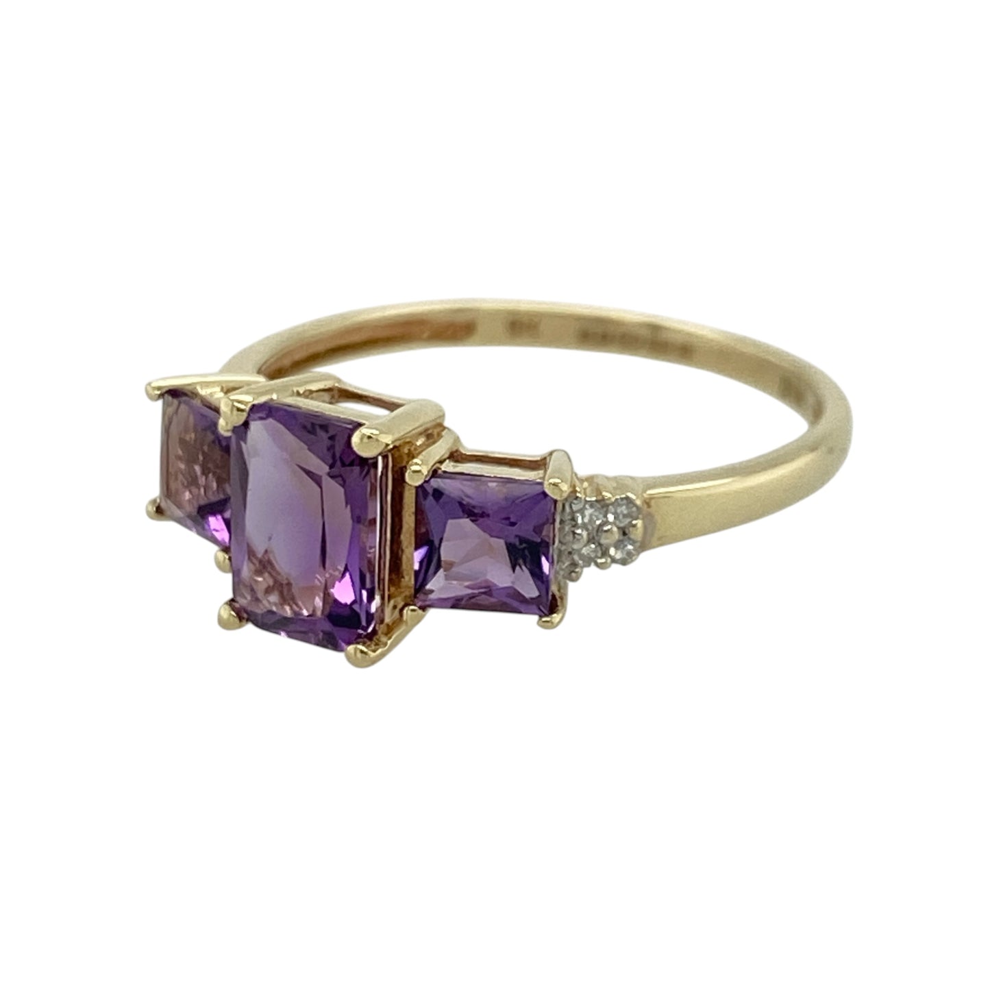 This pre-owned 9ct yellow gold diamond and amethyst trilogy ring is a colourful gemstone design, featuring three amethyst stones with diamond detailing.

Design: Featuring a rectangular centre amethyst with a square amethyst set on either side, this trilogy ring combines rich purple tones with diamond detailing and warm 9ct yellow gold.
Material: Made from 9-carat yellow gold.