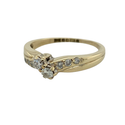 This pre-owned 9ct yellow gold diamond double twist ring is an elegant design, featuring a double twist setting with diamond-set shoulders.

Design: Featuring a double twist design with diamonds extending along the shoulders, this ring has a flowing style finished in warm 9ct yellow gold.
Material: Made from 9-carat yellow gold.
Gemstone Detail: Set with diamonds, including diamond detailing along the shoulders.
Ring Detail: Double twist ring design with diamond-set shoulders.