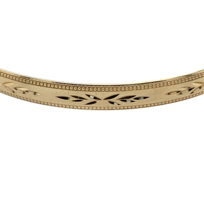 This pre-owned 9ct yellow solid gold patterned bangle is a substantial classic design, featuring decorative detailing throughout.

Design: Featuring a patterned design, this solid bangle has a decorative finish in warm 9ct yellow gold.
Material: Made from solid 9-carat yellow gold.
Bangle Detail: Bangle measures approximately 5mm wide with a diameter of approximately 6.7cm.
Size & Weight: Total weight 7.60 grams.